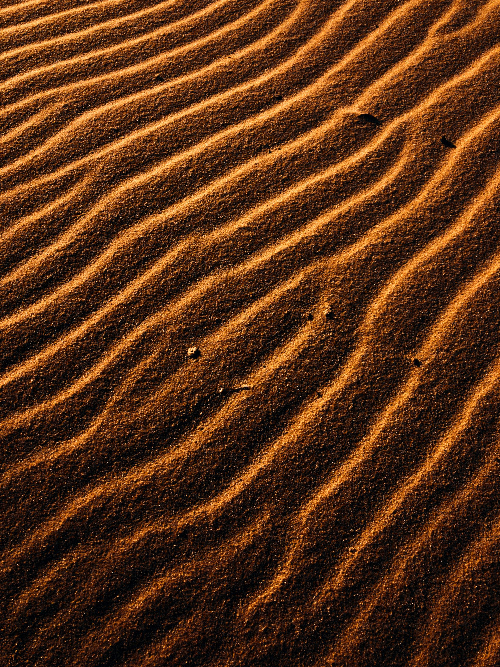 brown sand with shadow of person
